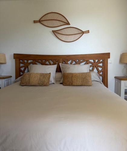 a large white bed with two pillows on it at Chambre 2 dans un petit paradis in La Londe-les-Maures
