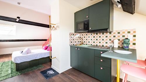 a small room with a sink and a bathroom at Pop Hôtel in Dijon
