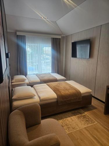 a bedroom with four beds and a window at Sport Hotel 2 in Cherkasy