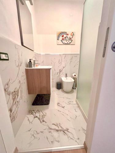 a bathroom with a sink and a toilet at Piombino Monolocale Poseidonia in Piombino