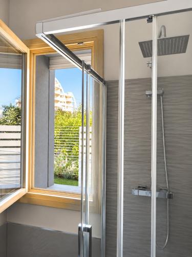 a shower in a bathroom with a window at Approdo del Re in Grottammare