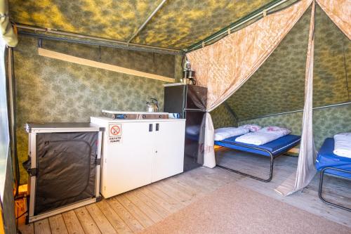 a room with a tent with two beds in it at Duynlodge Ameland direct aan het strand in Nes