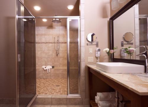 a bathroom with a shower with a sink and a shower at Grouse Mountain Lodge in Whitefish