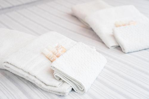 a pile of white towels sitting on a bed at Luna in Onifai