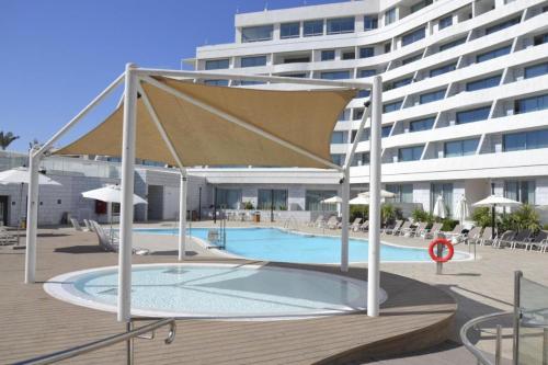 a large swimming pool with a large building in the background at סי סייד אילת - Sea Side Eilat in Eilat
