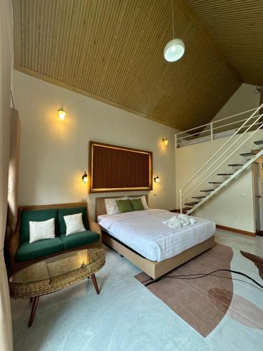 a bedroom with a bed and a stair case at ชอว์ งาทอง รีสอร์ต Chor Ngar Thong Erawan Kanchanaburi in Tha Kradan