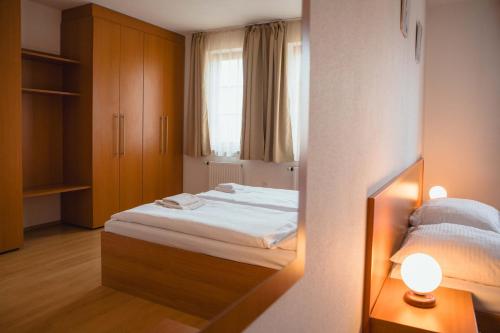 a small bedroom with a bed and a window at Apartmány Nový Svět in Třeboň II