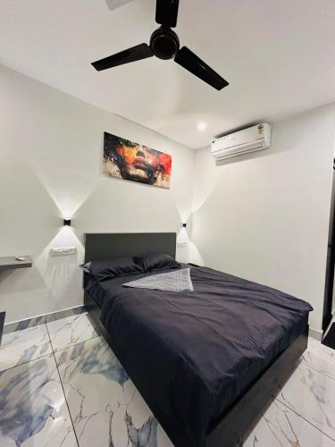 a bedroom with a bed with a ceiling fan at Restara Tower in Cochin