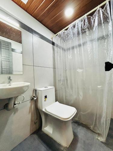 a bathroom with a toilet and a sink at Restara Tower in Cochin