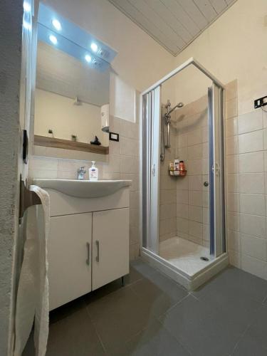 a bathroom with a sink and a shower at Luma Sixty nine in Alcamo