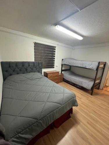 a bedroom with a bed and a couch in it at Central Apartment in Cochrane