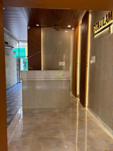 a lobby of a building with a sign on the wall at Hotel Gokulam Grand in Tenāli