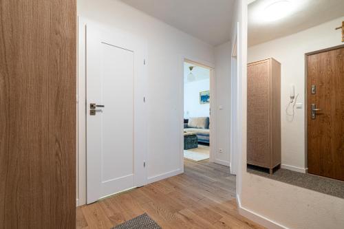 a room with a hallway with white walls and wooden floors at Apartament Flow Tatry in Zakopane