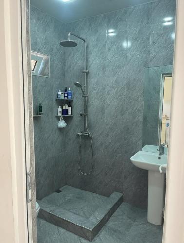 a bathroom with a shower and a sink at Арев in Yerevan