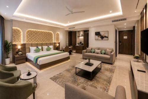 a hotel room with a bed and a living room at Hotel Veloria Grand IGI Airport Delhi in New Delhi