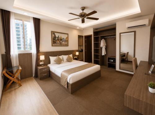 a bedroom with a bed and a ceiling fan at Norodom Clover Hotel in Phnom Penh