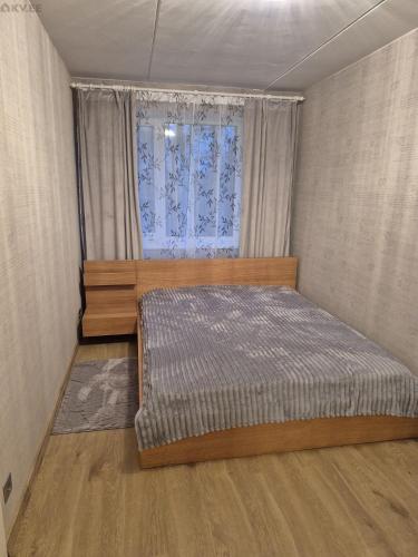 a bedroom with a bed and a window at Tamme apartment in Suuremõisa