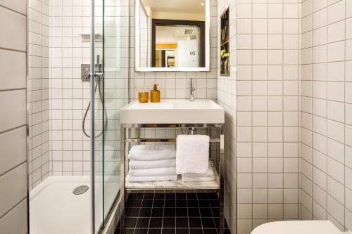 a bathroom with a sink and a shower at ARK Shoreditch in London