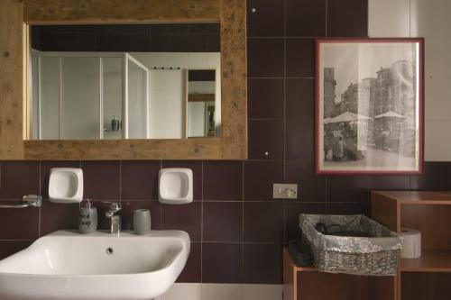 a bathroom with a sink and a mirror at El Lugo apartment in Colà di Lazise