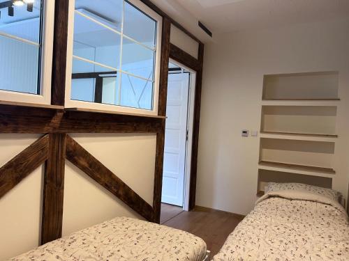 a bedroom with two beds and a window at Za Wysokim Murem in Czarne