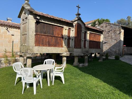 a table and chairs in front of a building at Casa de Gándara in Baiona