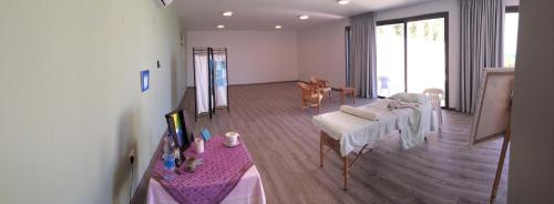 a living room with a table and a dining room at Aphrodite Beach Hotel in Polis Chrysochous
