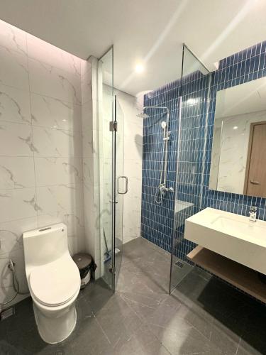 a bathroom with a toilet and a shower and a sink at Angela House Halong in Ha Long