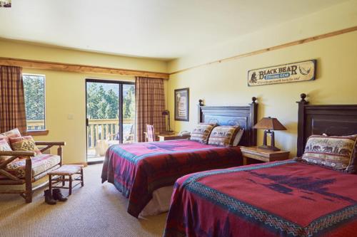 a bedroom with two beds and a balcony at St. Mary Village in Saint Mary