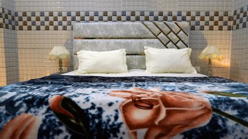 a bedroom with a large bed with a flower on it at Kanta Sant Ram Aashram in Haridwār