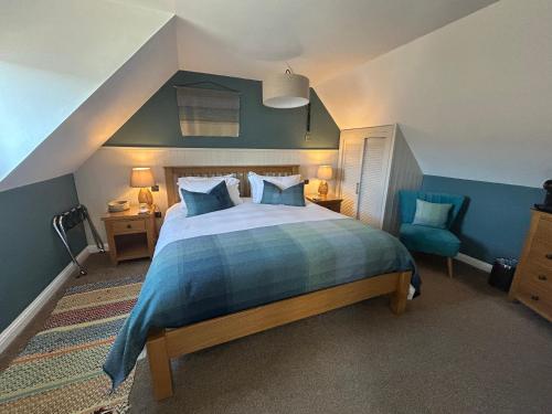 a bedroom with a large bed with blue walls at Ceol na Mara Guest House in Tarbert