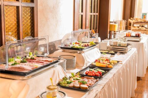 a buffet line with many different types of food at Hotel zur Post in Hemmingen