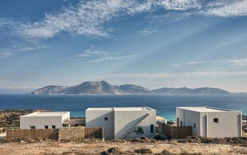 a group of white buildings in front of the ocean at Koufonisi Villa Kallisti in Koufonisia