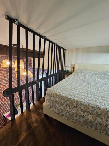 a bedroom with a bed on a balcony at Duplex à 15 min à pieds de la gare, centre historique Montluçon in Montluçon