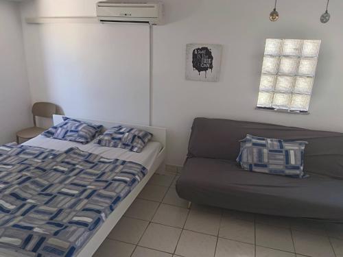 a bedroom with a bed and a couch at Apatmani Čriček in Vlašići