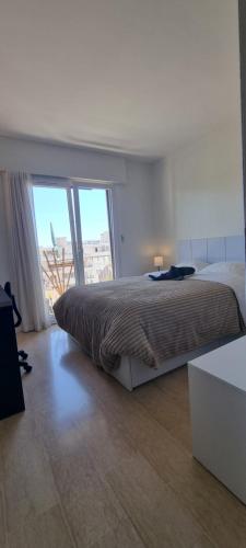 a bedroom with a large bed and a large window at Chambres d'hôtes - Bed & Breakfast - chez Denis-Jo in Toulon
