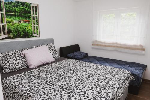 a bedroom with a bed and a window at Vikendica Trebižat river in Čapljina