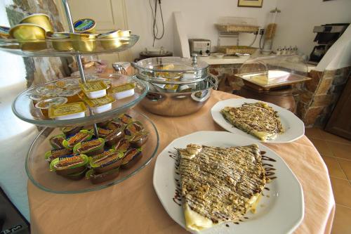 a table topped with plates of food and desserts at Hotel Castillio in Analipsi