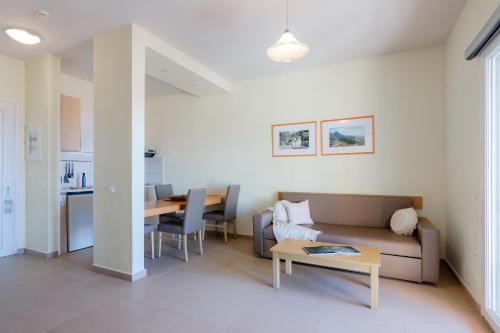 a living room with a couch and a table at Hotel Estia in Finikounta