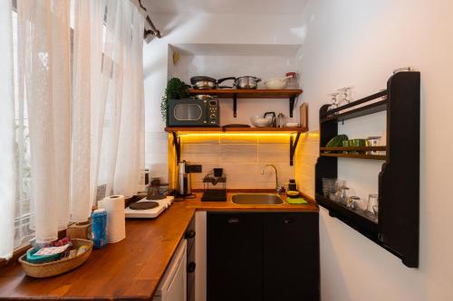 a small kitchen with a sink and a microwave at 62 HOME in Marmaris