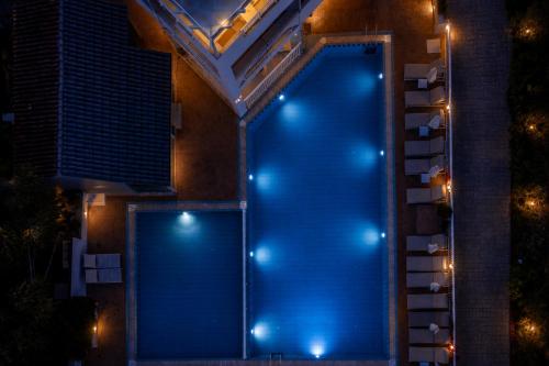 a swimming pool with blue lights on the side of a house at Zante Pantheon Hotel in Tsilivi