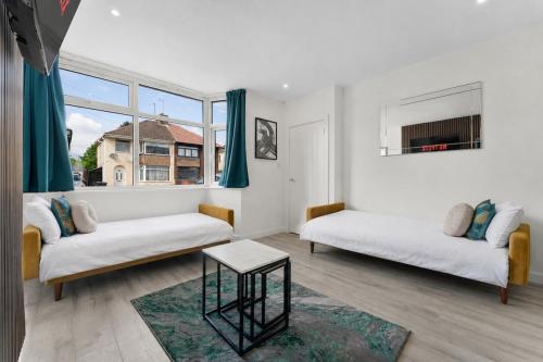 a living room with two beds and a window at Modern House, Pool Table, Parking & Garden in Fallings Park
