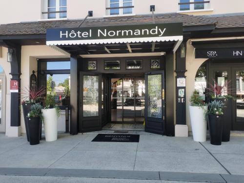a hotel normanny entrance to a building at Hôtel Le Normandy - Maison Tassoni in Vernon