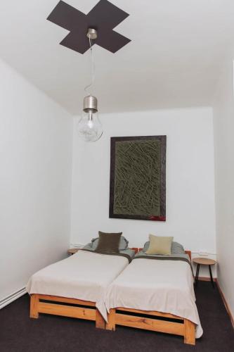 a bedroom with two beds and a ceiling fan at ArtHause in Gubin