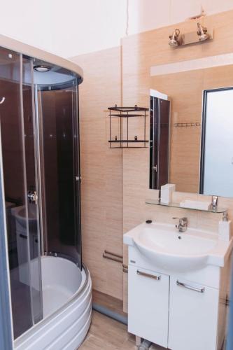 a bathroom with a shower and a sink and a tub at ArtHause in Gubin