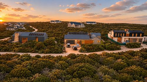 an aerial view of a home in the hills at Cast Away at Romansbaai - Salted Fynbos Staying in Gansbaai
