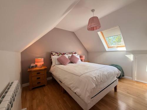 a bedroom with a bed with pillows and a window at Peaceful Red Deer Cosy Apt in Letterfrack near The Connemara National Park in Letterfrack