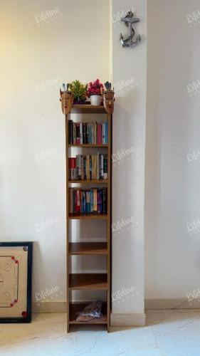 a book shelf filled with books in a room at The Mariners Plunder - A Sea Facing Escape in Avas