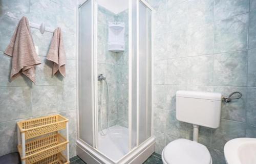 a bathroom with a shower and a toilet at Apartments by the sea Metajna, Pag - 6289 in Zubovići
