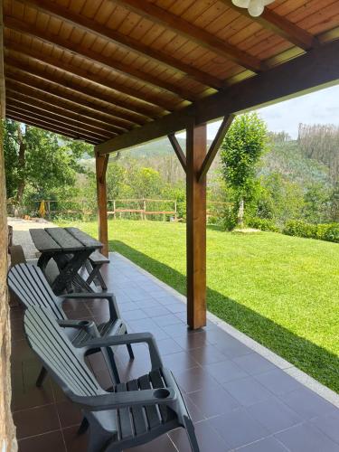two chairs and a table on a patio with a view at Casa do Canastro in Sever do Vouga