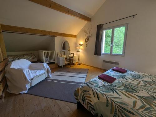 a bedroom with a bed and a large window at De l'onde au vert in Vivey
